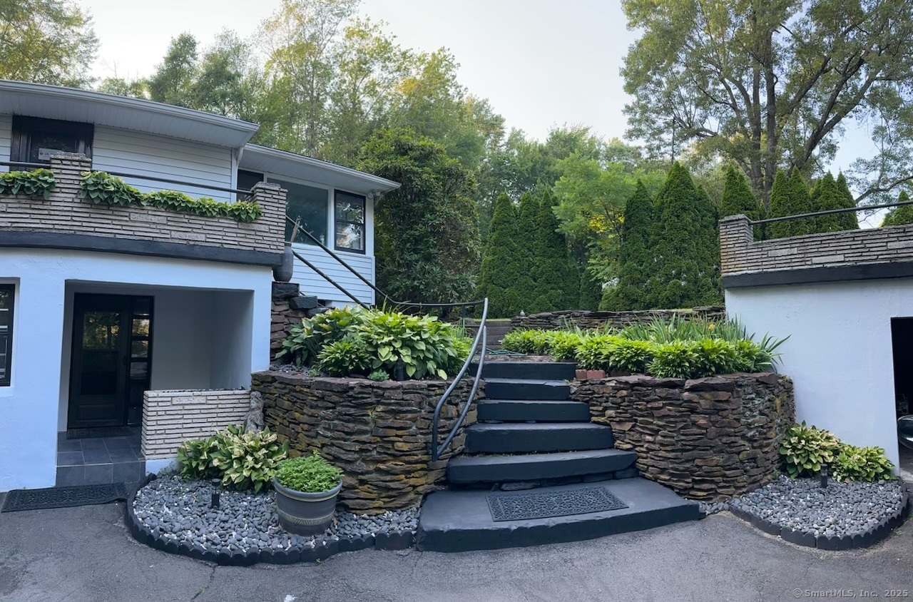 a view of a house with potted plants