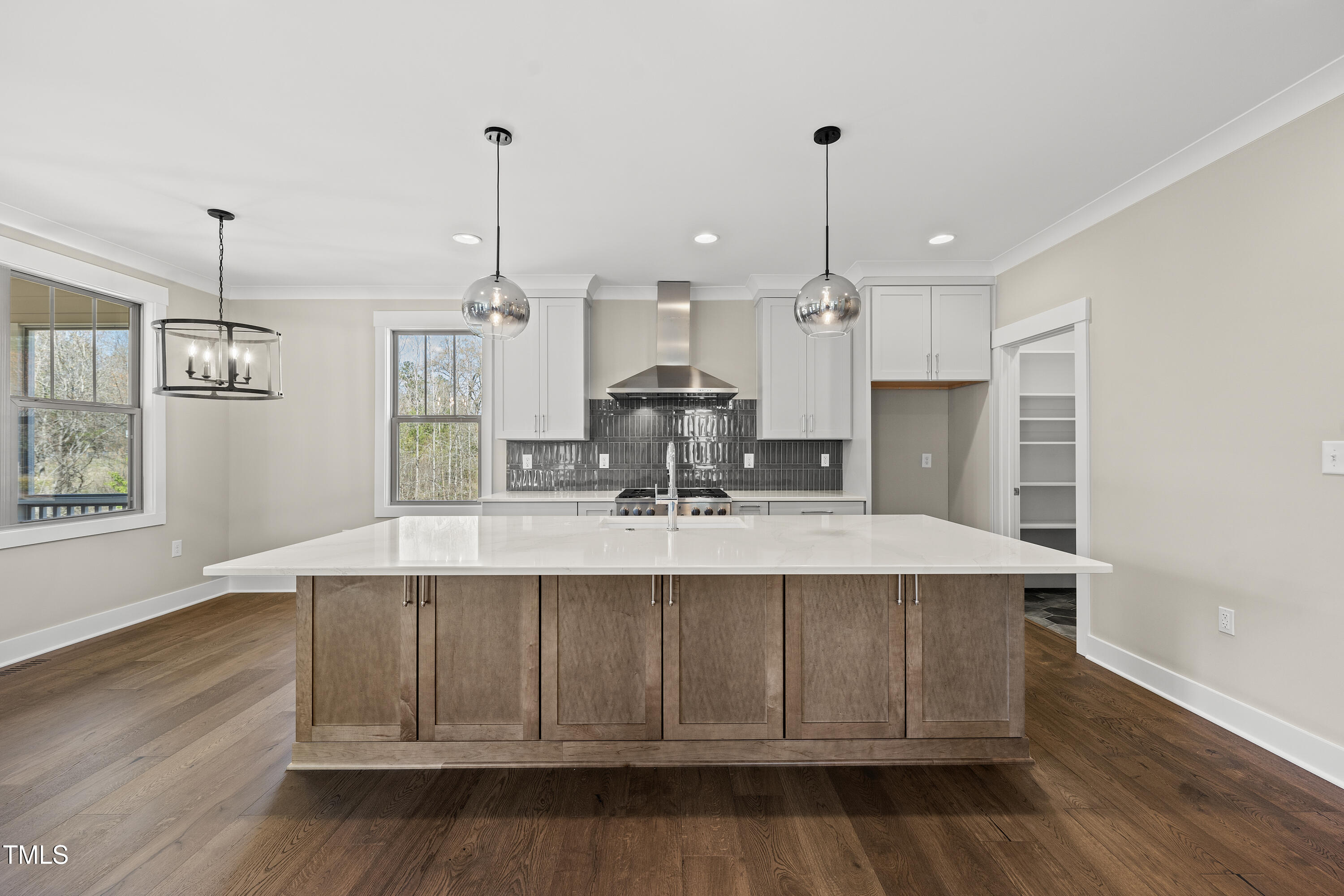 10119 2nd Star Court Raleigh, NC 27613 - Photo 12 of 39 a view of a kitchen with kitchen island stainless steel appliances wooden floor and window