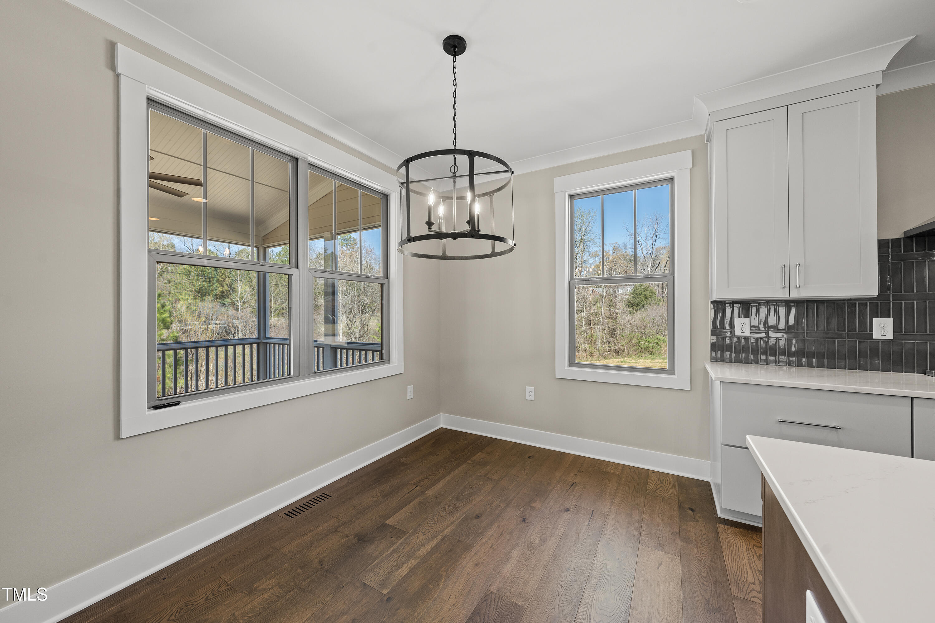 10119 2nd Star Court Raleigh, NC 27613 - Photo 13 of 39 a view of a room with wooden floor and windows