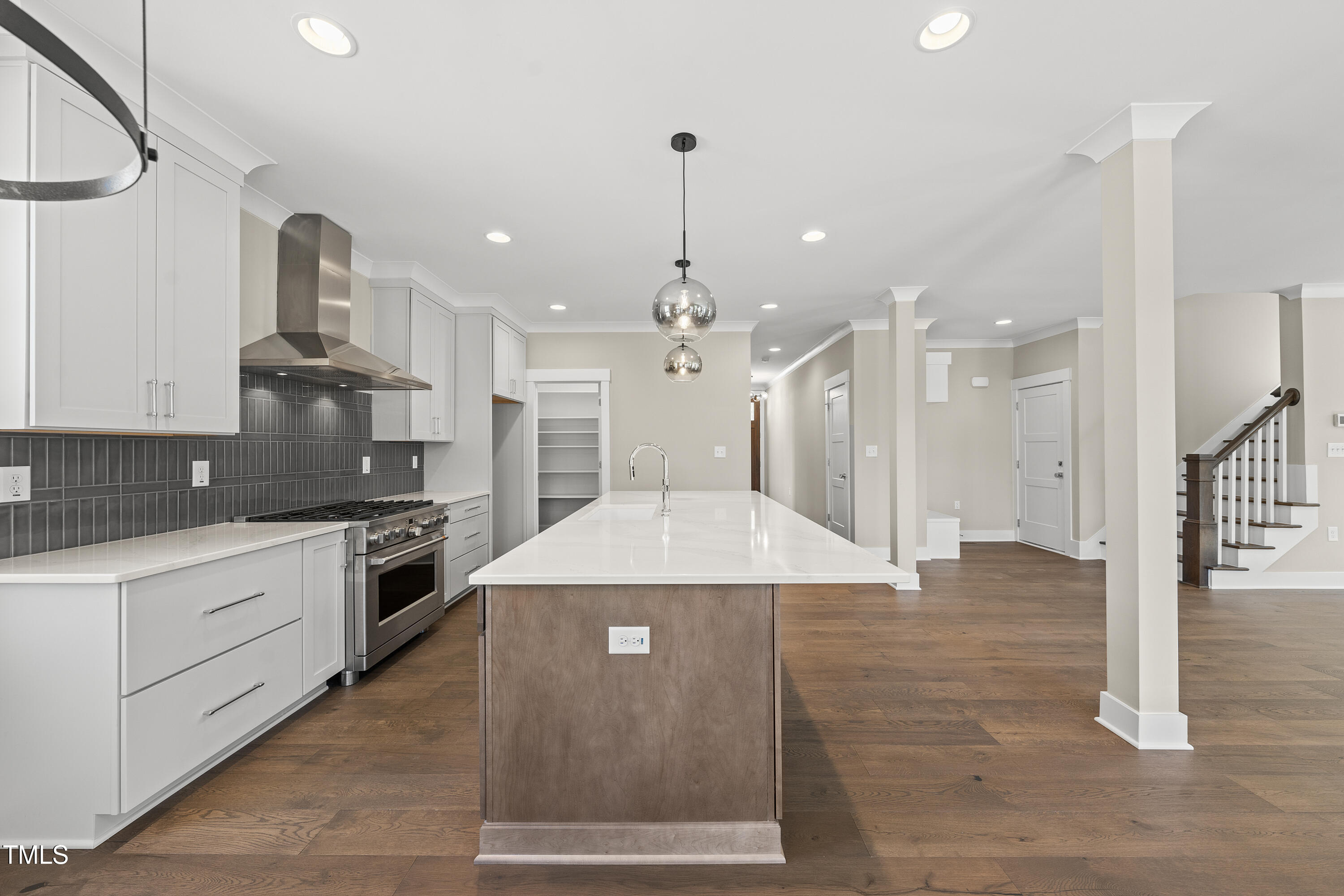 10119 2nd Star Court Raleigh, NC 27613 - Photo 14 of 39 a large kitchen with granite countertop a stove a sink dishwasher and a refrigerator with wooden floor
