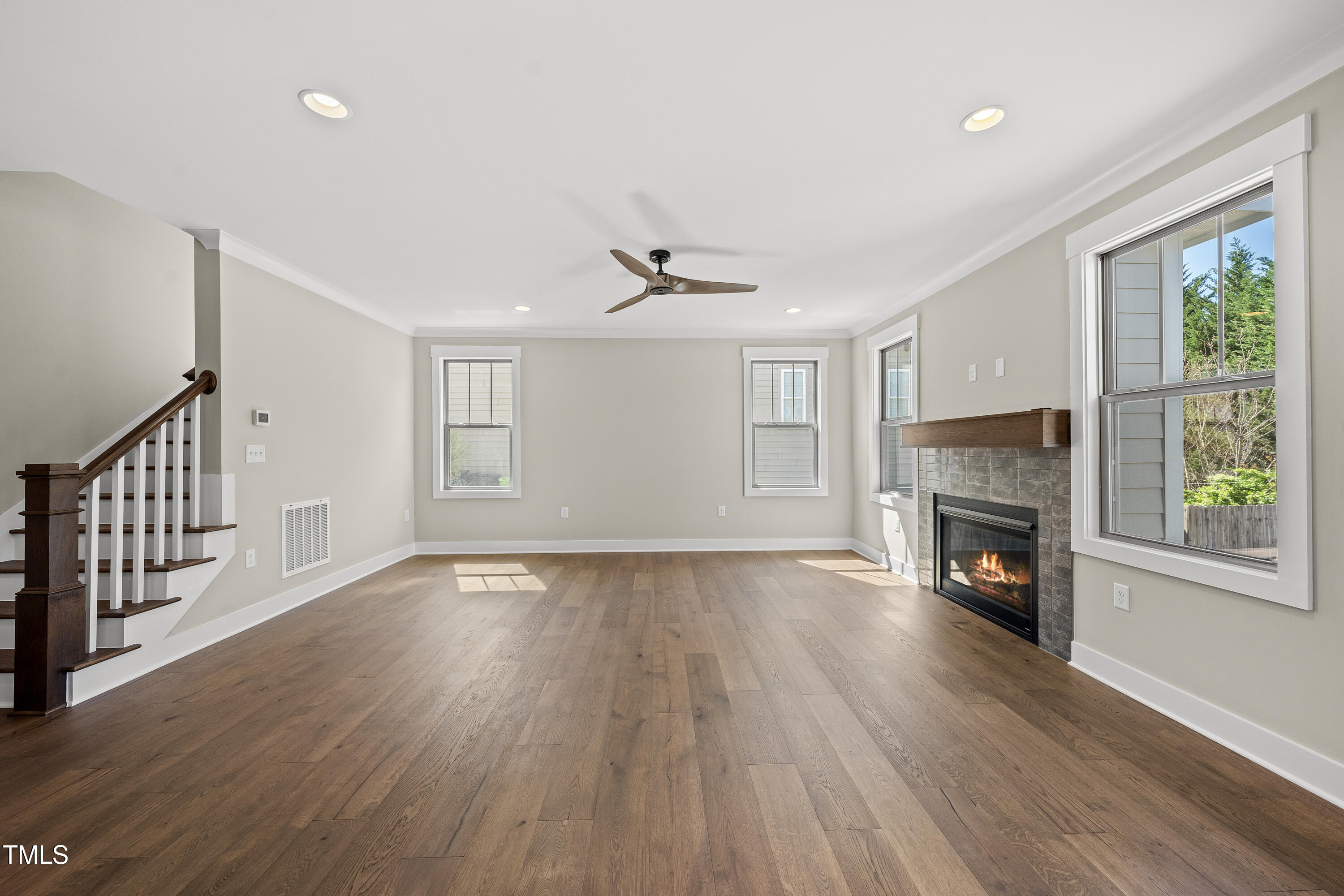 10119 2nd Star Court Raleigh, NC 27613 - Photo 17 of 39 a view of an empty room with wooden floor fireplace and a window