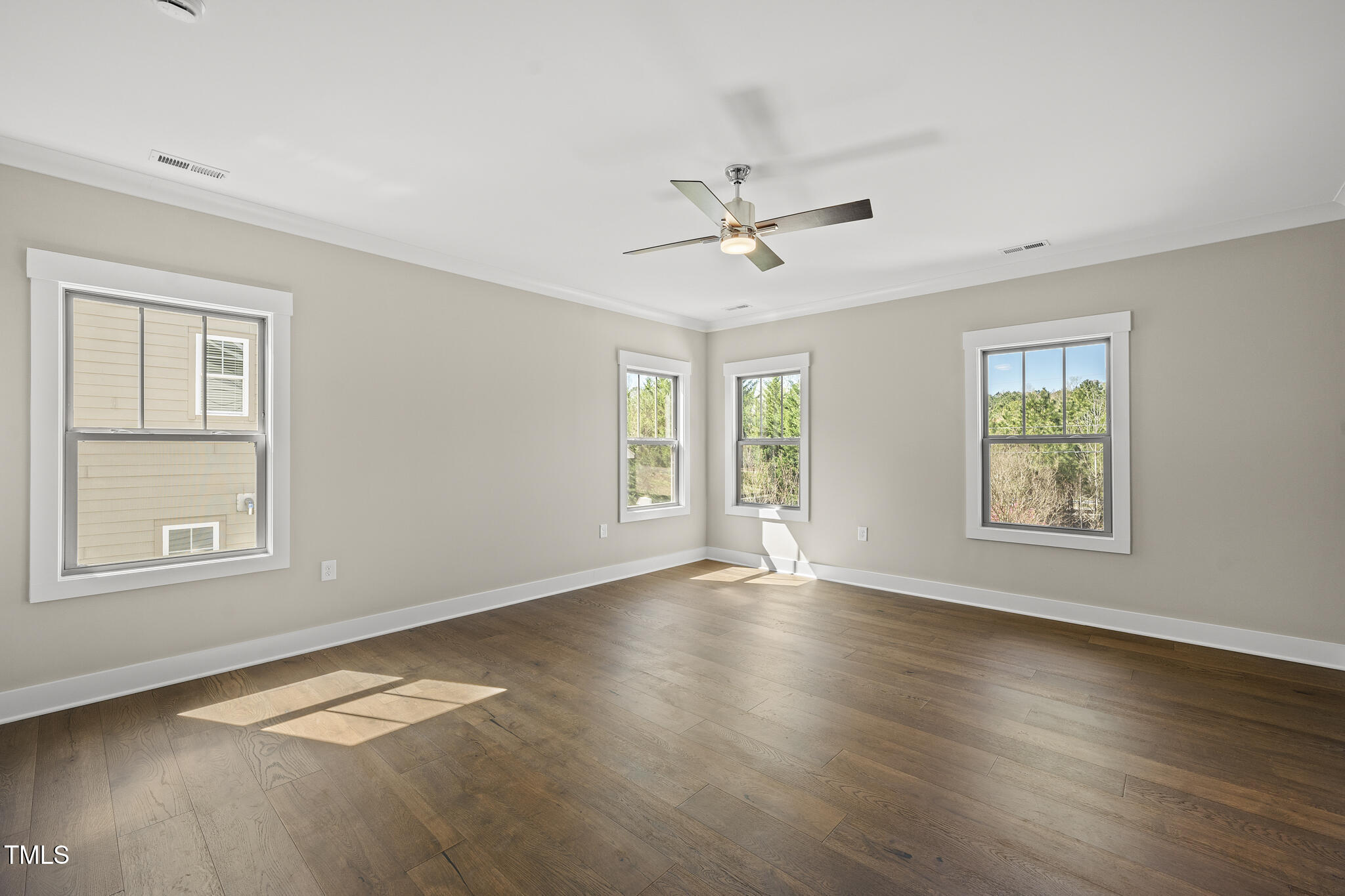 10119 2nd Star Court Raleigh, NC 27613 - Photo 20 of 39 a view of an empty room with a window and wooden floor