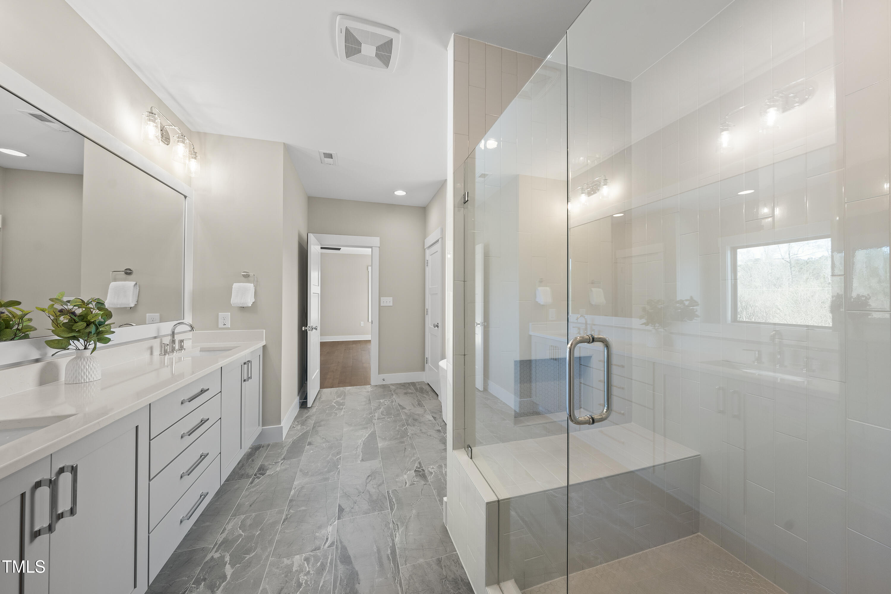 10119 2nd Star Court Raleigh, NC 27613 - Photo 22 of 39 a bathroom with a double vanity sink toilet and shower