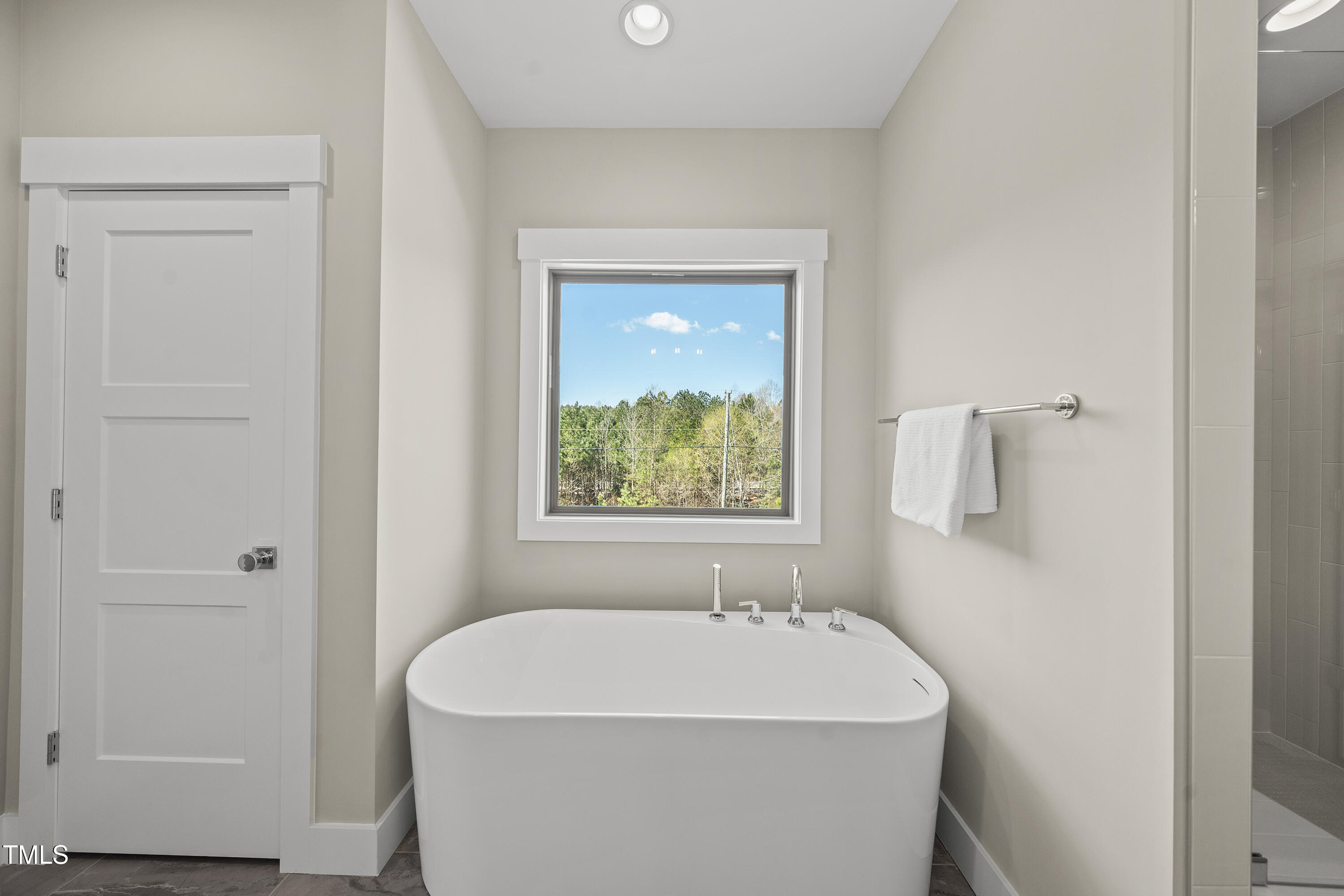 10119 2nd Star Court Raleigh, NC 27613 - Photo 23 of 39 a white bath tub sitting next to a white sink