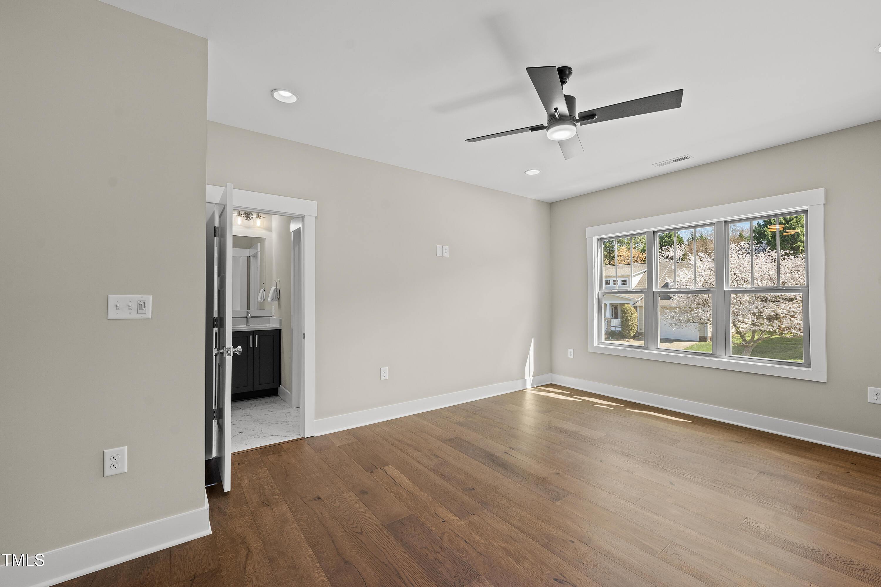 10119 2nd Star Court Raleigh, NC 27613 - Photo 26 of 39 wooden floor in an empty room with a window
