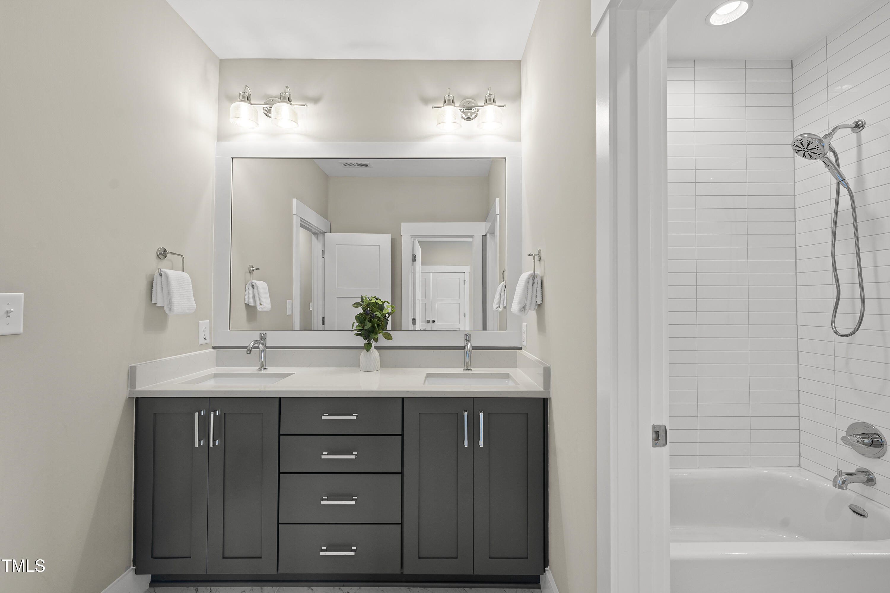 10119 2nd Star Court Raleigh, NC 27613 - Photo 27 of 39 a bathroom with a granite countertop sink mirror and a