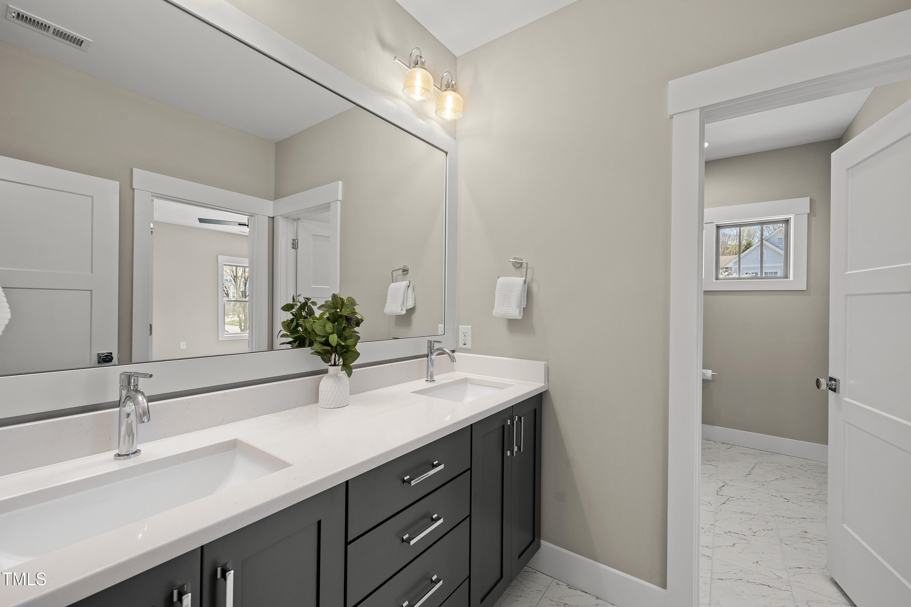 10119 2nd Star Court Raleigh, NC 27613 - Photo 28 of 39 a bathroom with a sink and a mirror