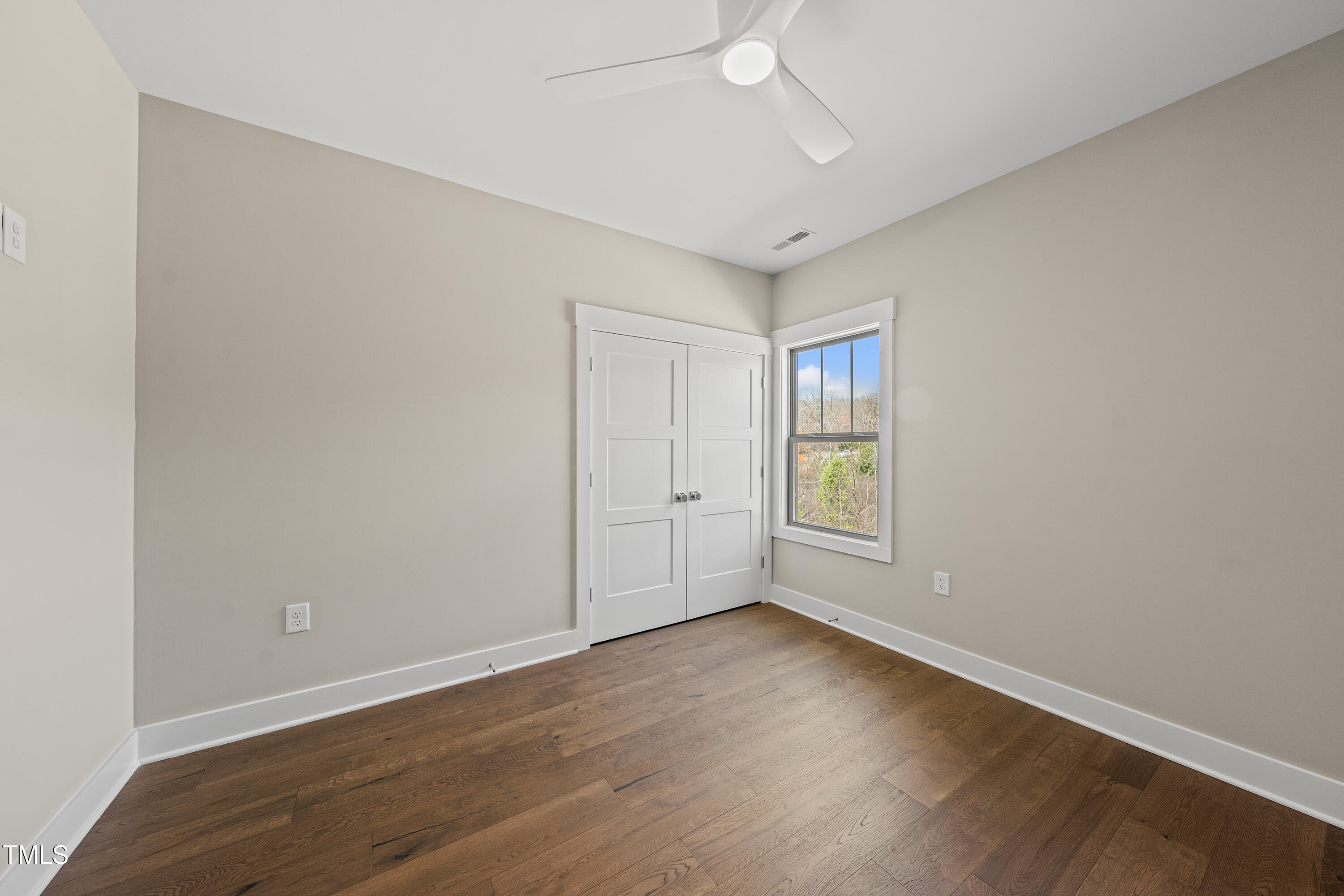 10119 2nd Star Court Raleigh, NC 27613 - Photo 31 of 39 a view of an empty room with wooden floor and window