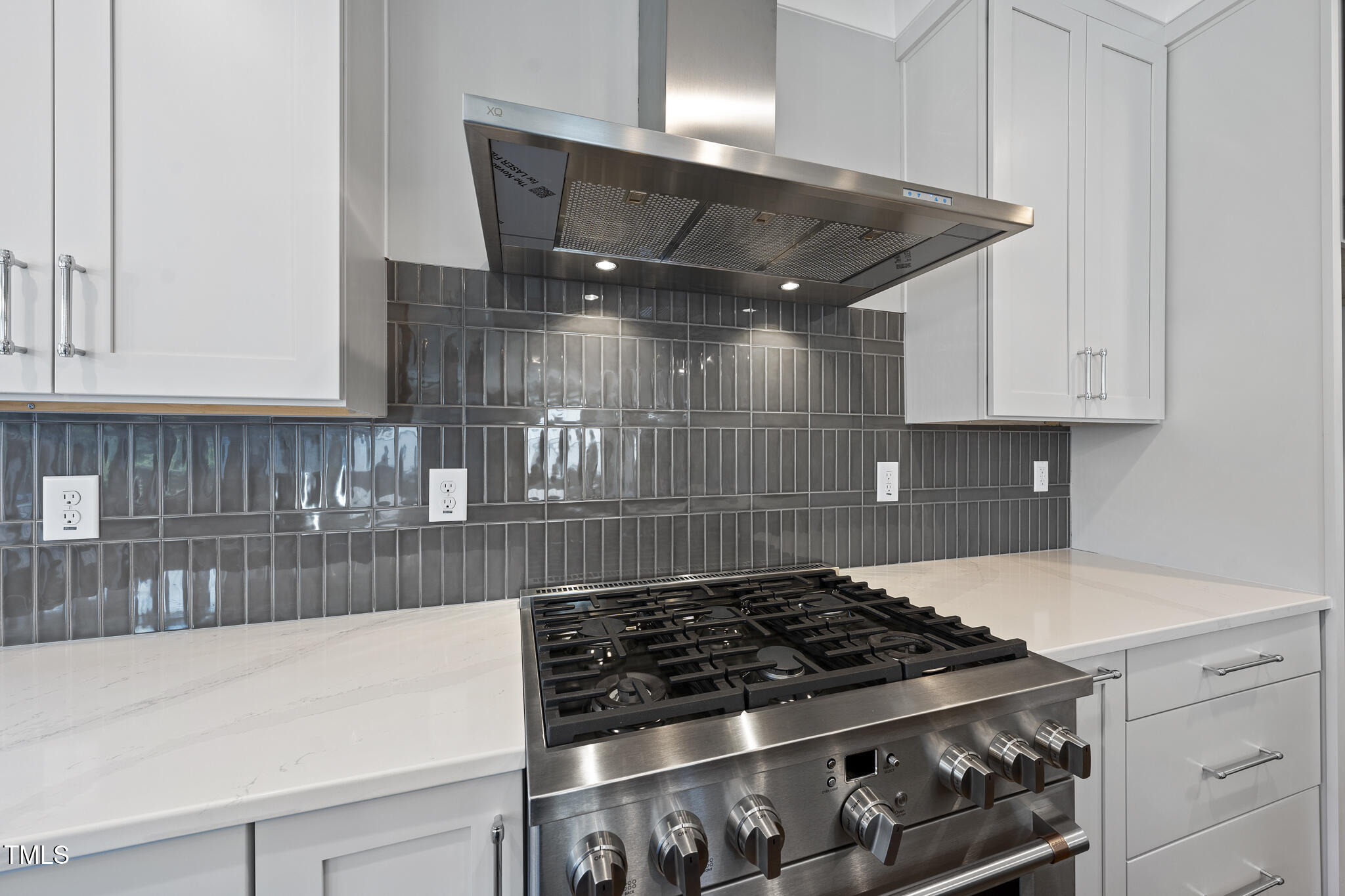 10119 2nd Star Court Raleigh, NC 27613 - Photo 4 of 39 a kitchen with granite countertop a stove and white cabinets