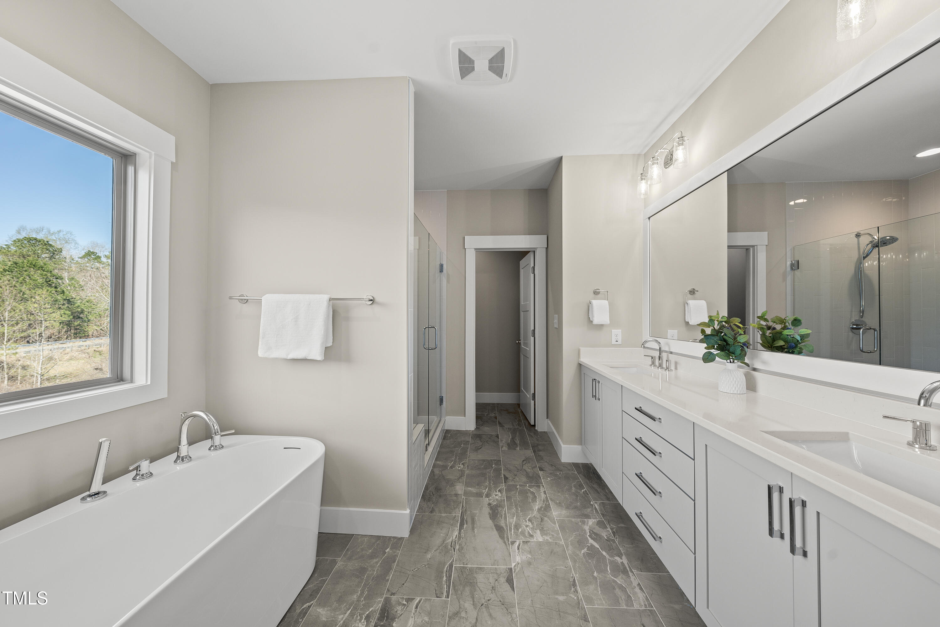 10119 2nd Star Court Raleigh, NC 27613 - Photo 6 of 39 a bathroom with a tub sink and mirror