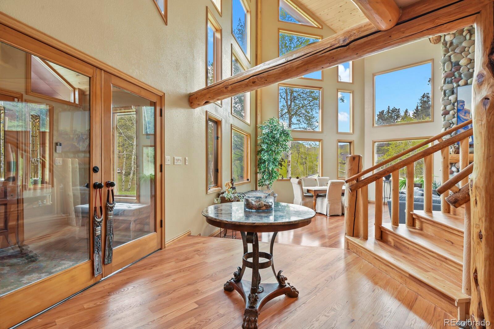 417 Witter Gulch Road Evergreen, CO 80439 - Photo 4 of 50 a view of a livingroom with furniture and front door