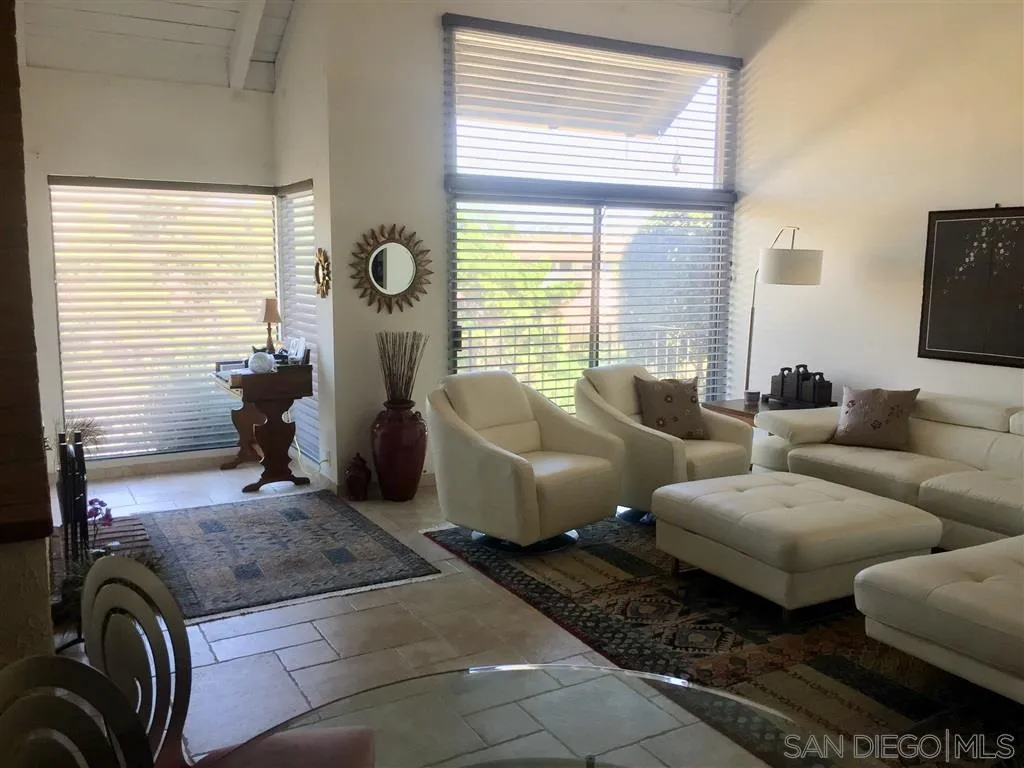 a living room with furniture wooden floor and window