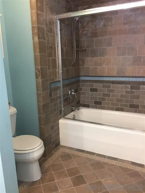 1939 Alga Road, Unit A Carlsbad, CA 92009 - Photo 11 of 25 a bathroom with a white toilet sitting next to a shower
