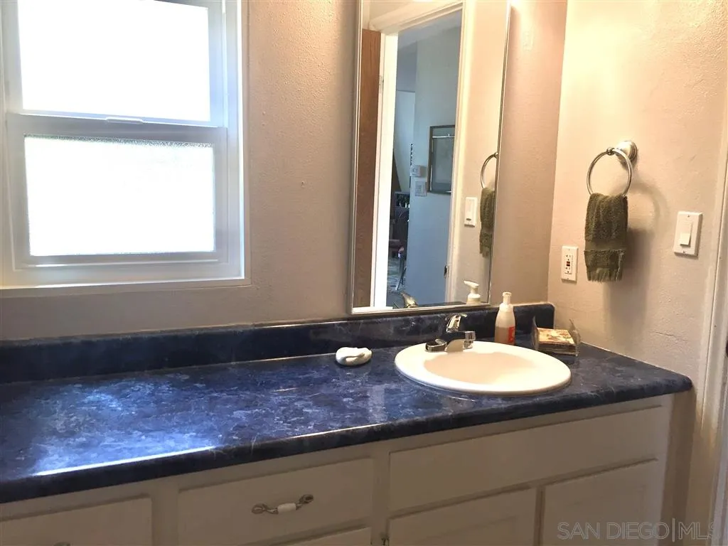 1939 Alga Road, Unit A Carlsbad, CA 92009 - Photo 17 of 25 a bathroom with a sink and a mirror