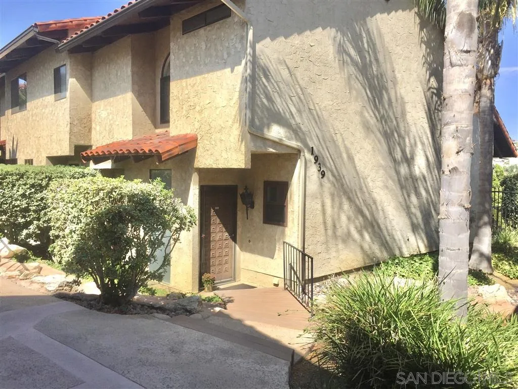 1939 Alga Road, Unit A Carlsbad, CA 92009 - Photo 2 of 25 a front view of a house with a yard