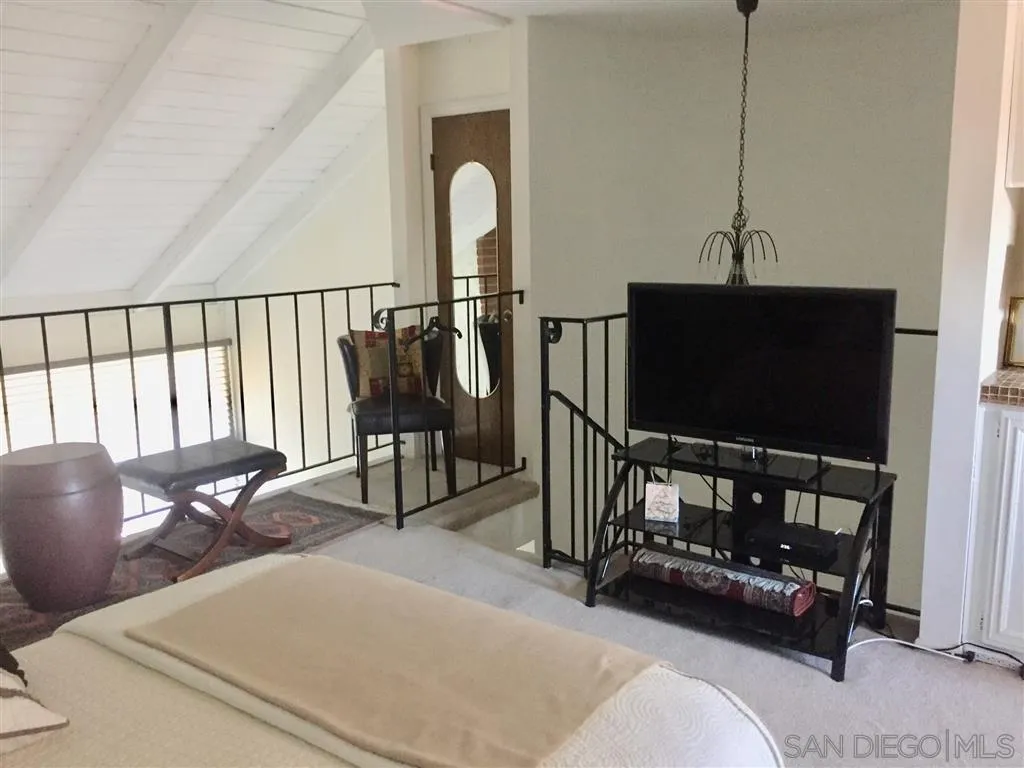 1939 Alga Road, Unit A Carlsbad, CA 92009 - Photo 7 of 25 a living room with furniture a flat screen tv and a window