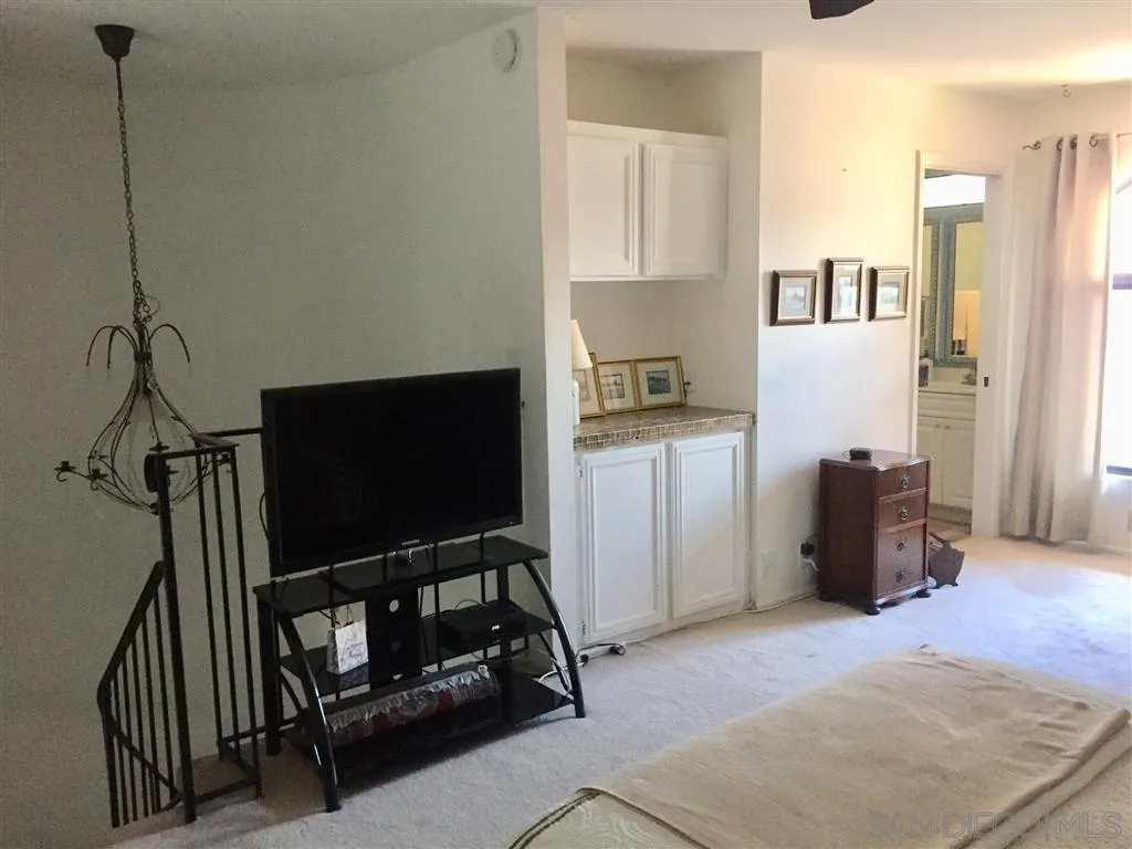 1939 Alga Road, Unit A Carlsbad, CA 92009 - Photo 8 of 25 a living room with furniture and a flat screen tv
