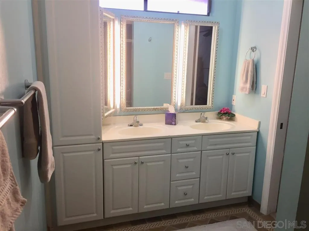 1939 Alga Road, Unit A Carlsbad, CA 92009 - Photo 10 of 25 a bathroom with a double vanity sink and a mirror