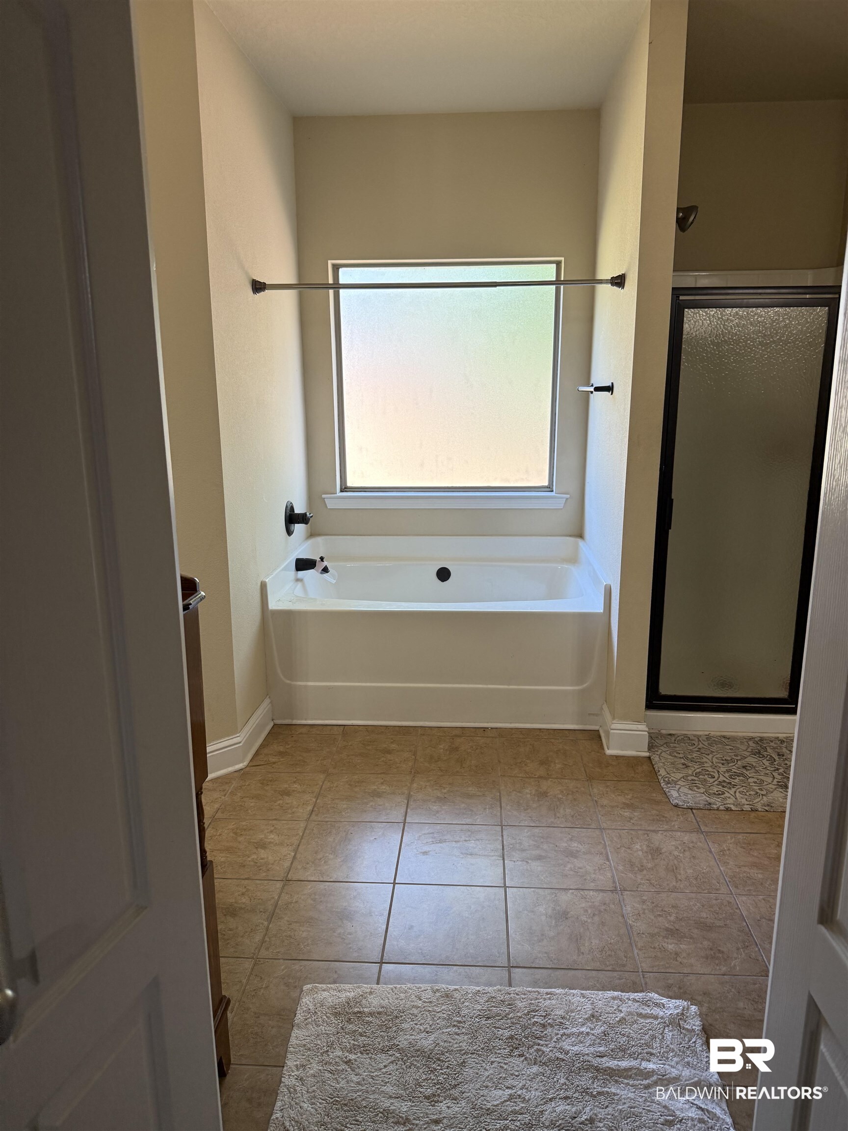 9023 Krystal Ridge Court Daphne, AL 36526 - Photo 20 of 41 Bathroom featuring a garden tub, a shower stall, and light tile patterned floors