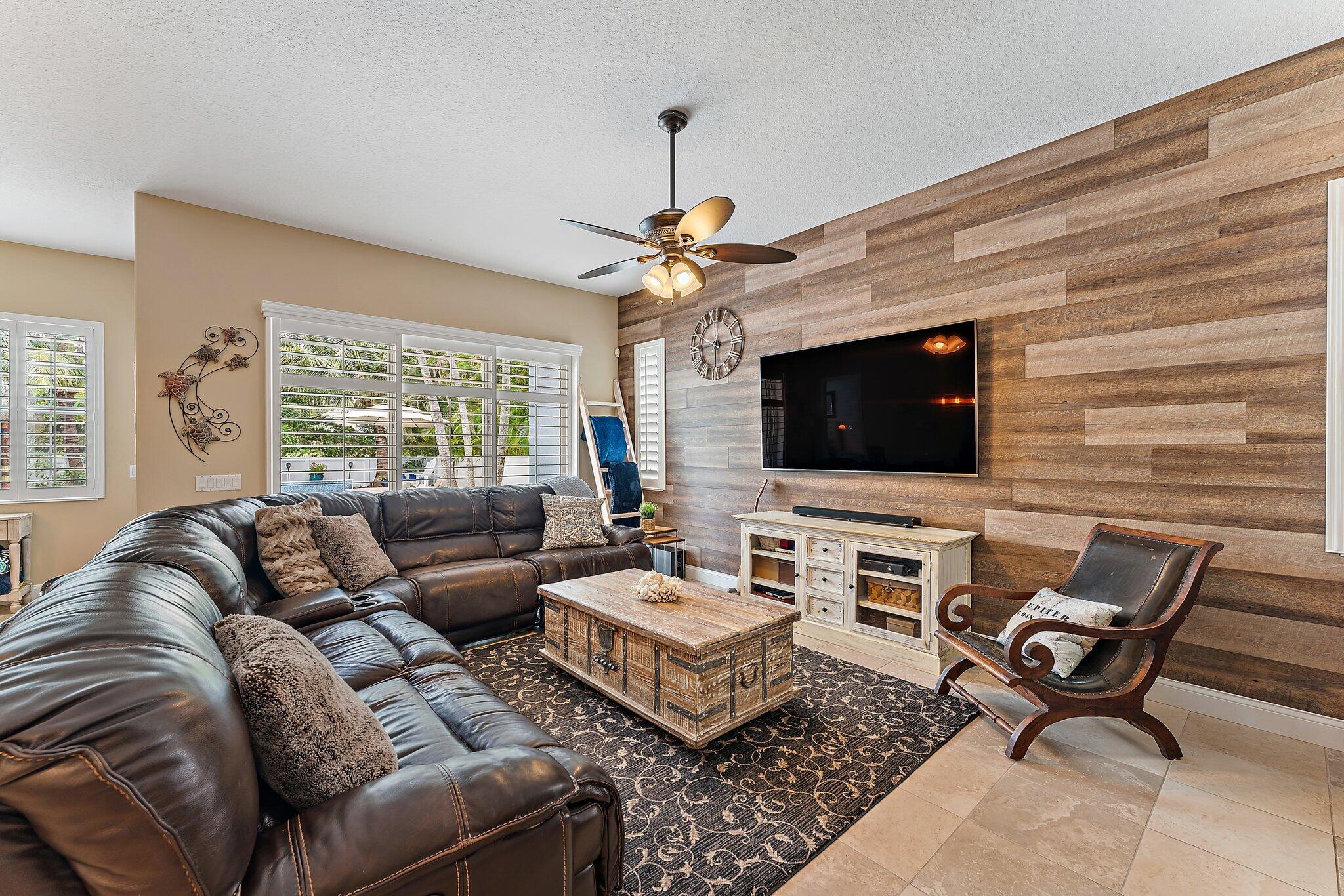 334 Caravelle Drive Jupiter, FL 33458 - Photo 20 of 55 a living room with furniture a flat screen tv and a chandelier