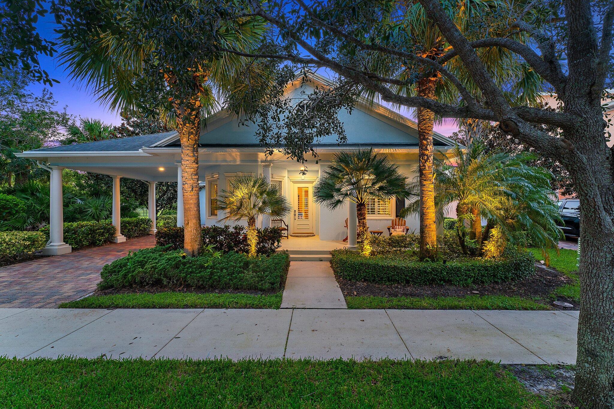 334 Caravelle Drive Jupiter, FL 33458 - Photo 2 of 55 a front view of a house with garden