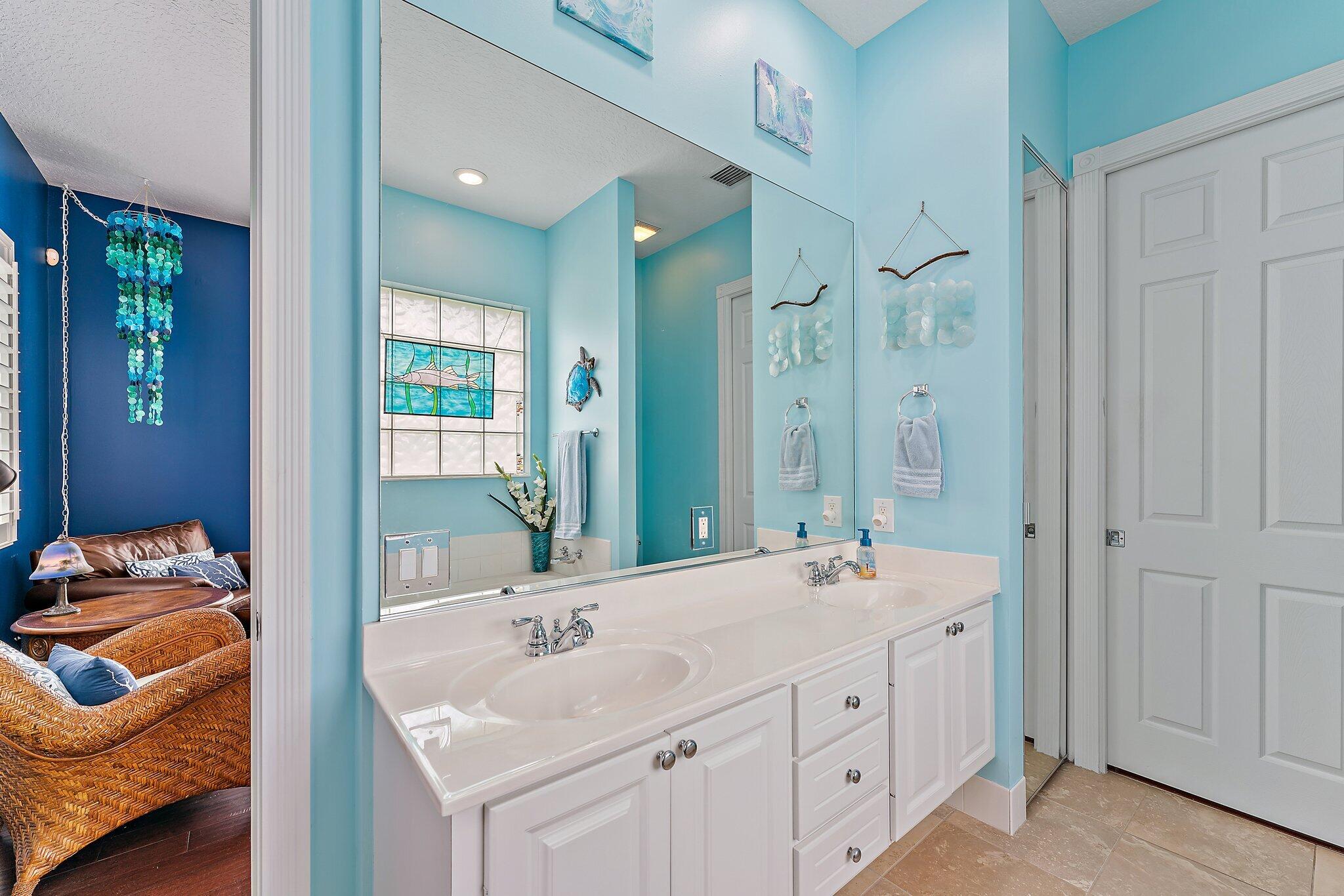 334 Caravelle Drive Jupiter, FL 33458 - Photo 27 of 55 a bathroom with a double vanity sink and a mirror