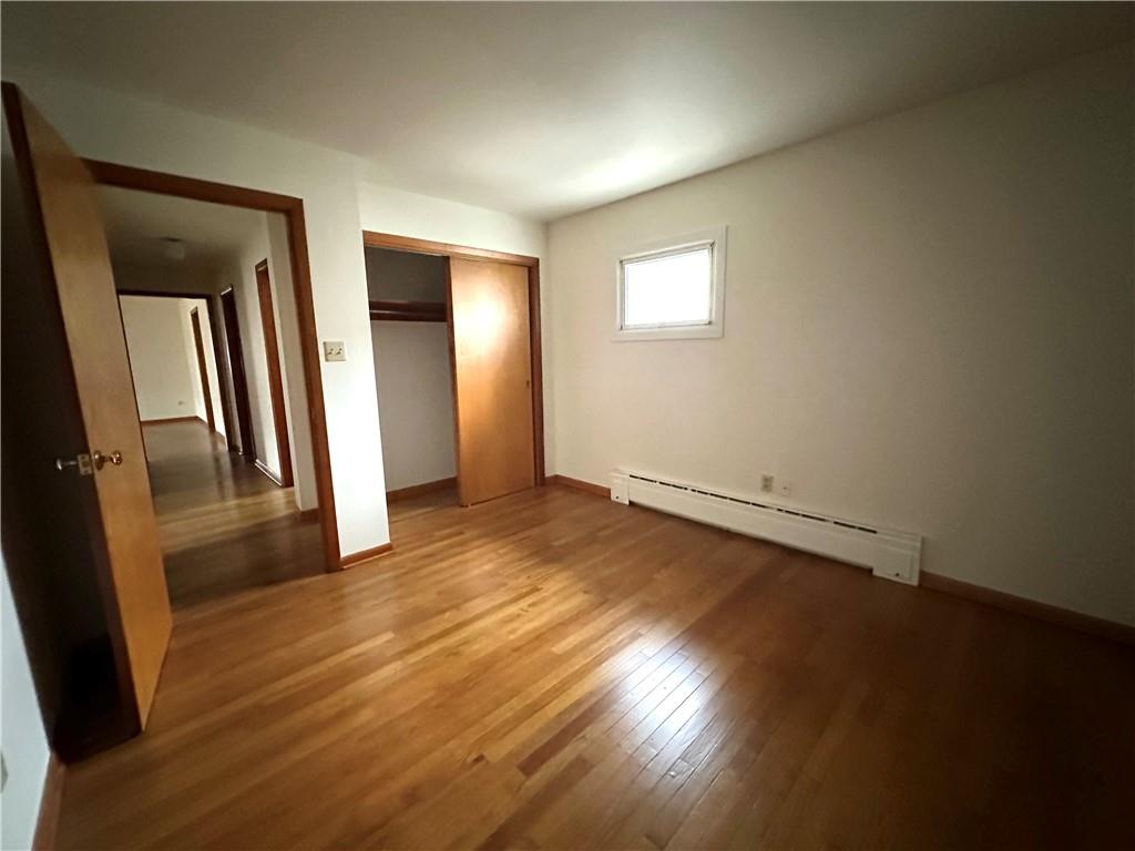 116 East Main Street Ligonier, PA 15658 - Photo 15 of 17 an empty room with wooden floor and windows