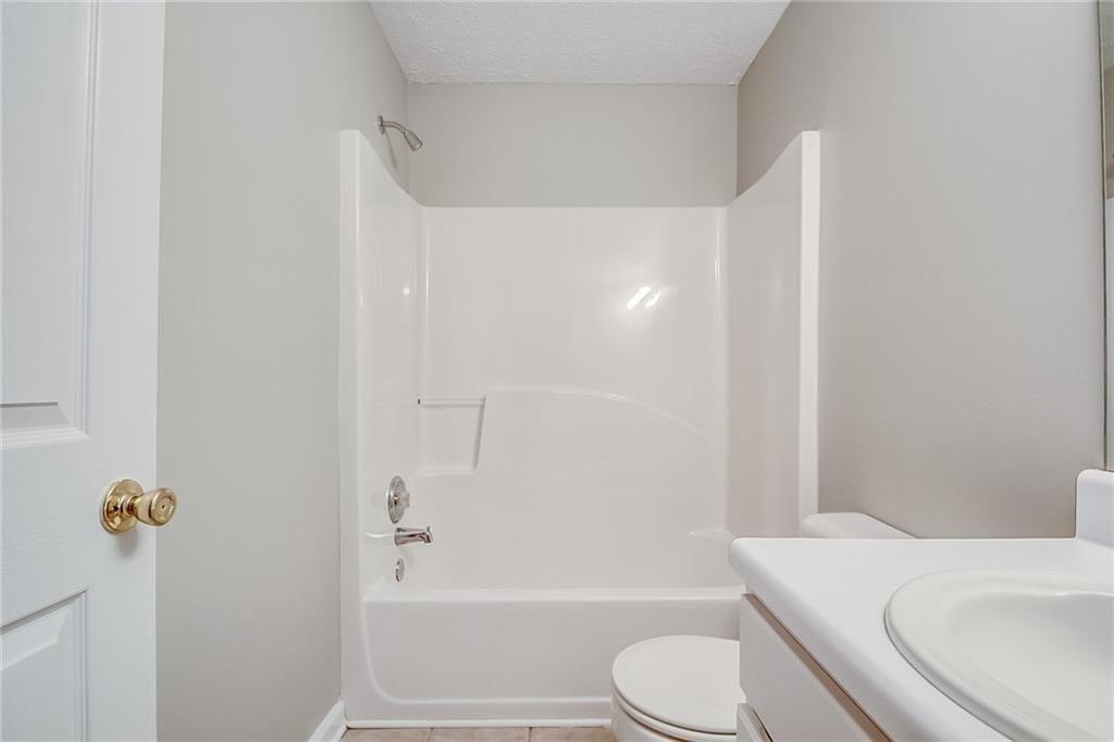 1643 Jackson Way Atlanta, GA 30318 - Photo 13 of 22 a bathroom with a toilet and a bath tub
