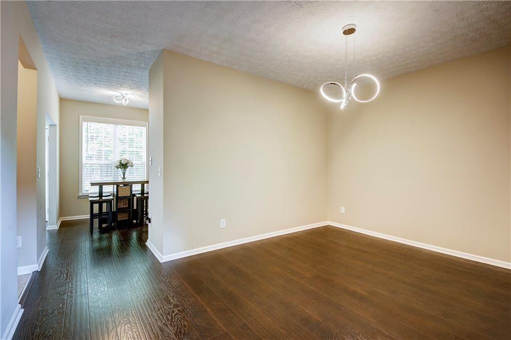 1643 Jackson Way Atlanta, GA 30318 - Photo 5 of 22 a view of a room with wooden floor and bench