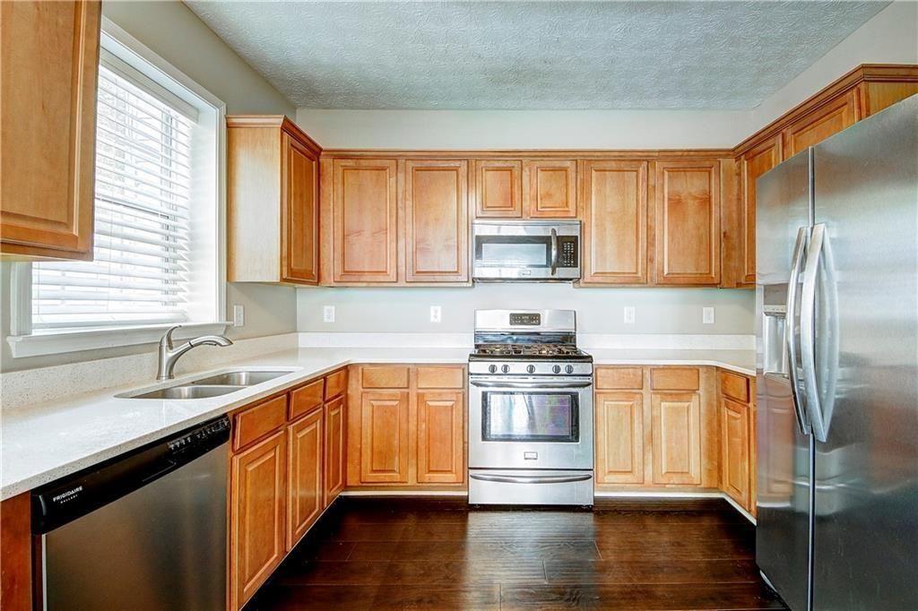 1643 Jackson Way Atlanta, GA 30318 - Photo 8 of 22 a kitchen with stainless steel appliances granite countertop a sink a stove and refrigerator
