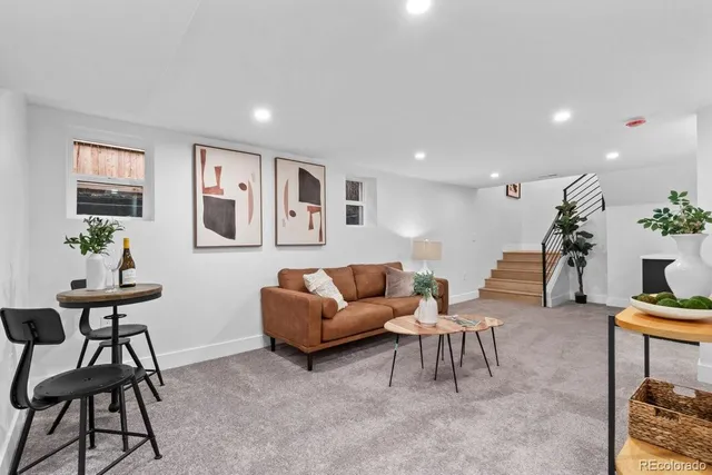 a living room with furniture and a potted plant