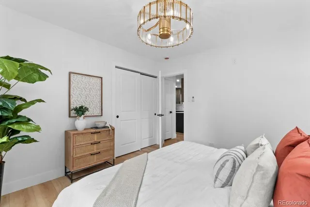 a bedroom with a bed and a chandelier