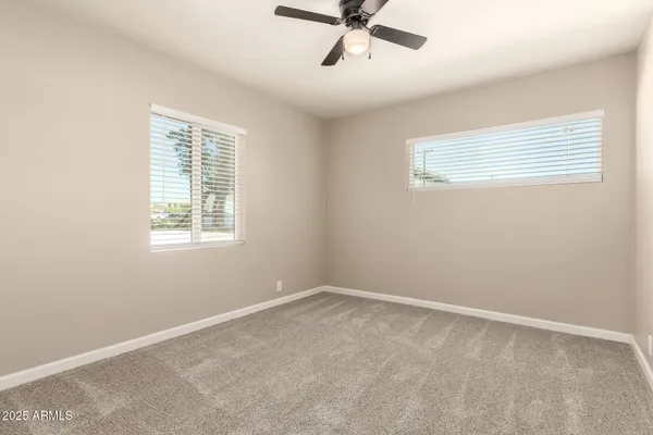 a view of a room with a ceiling fan and a window