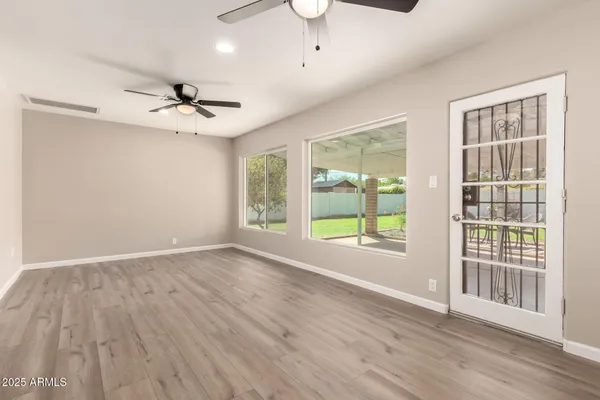 a living room with furniture and view of kitchen