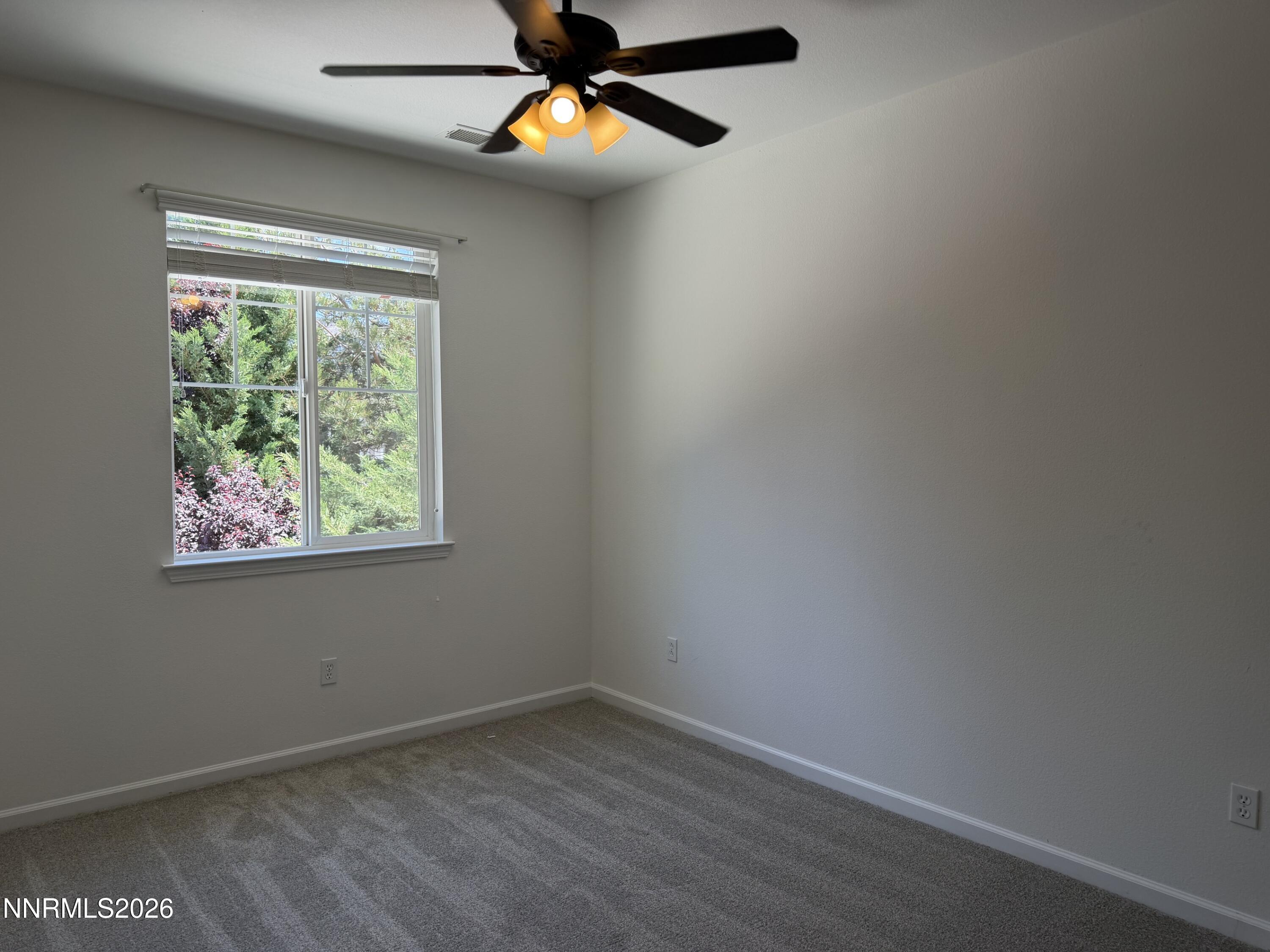 10890 Oakhaven Drive Reno, NV 89521 - Photo 21 of 28 an empty room with window and ceiling fan