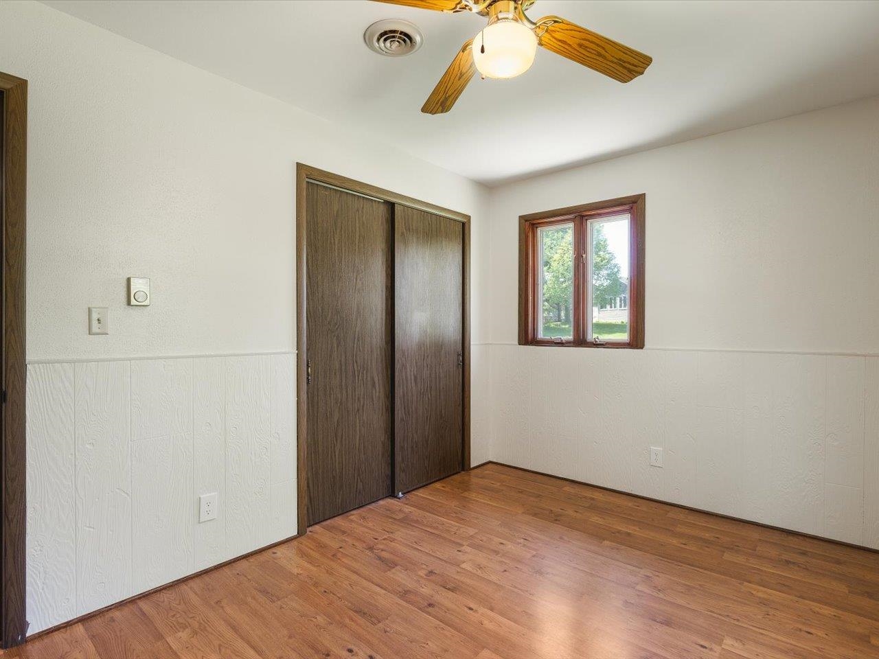 136 Lake Summerset Road Lake Summerset, IL 61019 - Photo 18 of 47 a view of empty room with wooden floor and ceiling fan