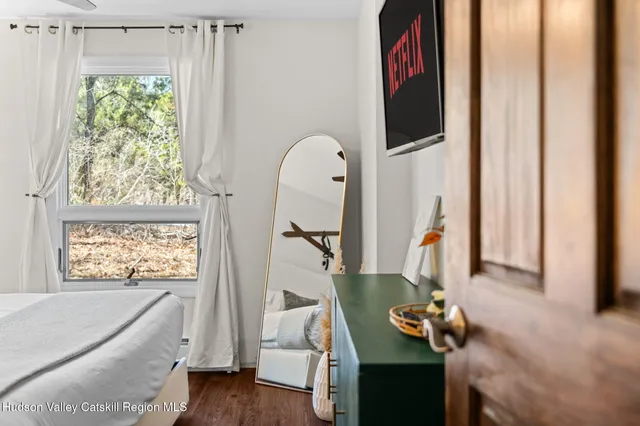 a living room with a bed furniture and a window