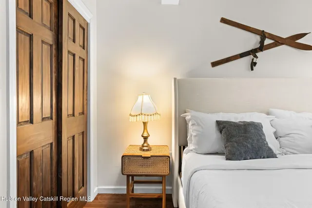 a bedroom with a bed and a flat screen tv