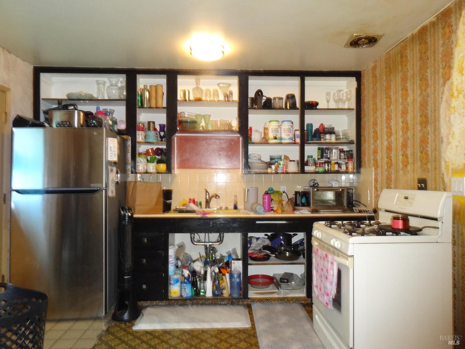 1005 Temple Avenue Santa Rosa, CA 95404 - Photo 7 of 20 a kitchen with refrigerator and cabinets