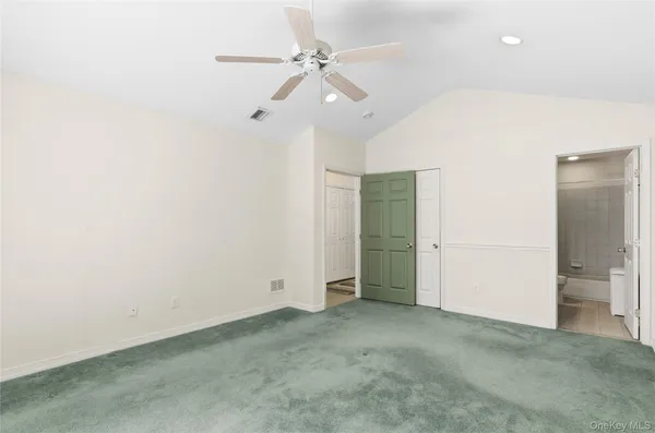 an empty room with fan and entrance