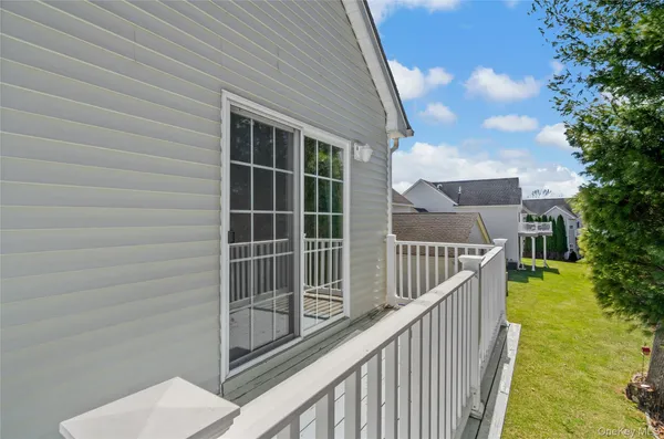 a view of balcony with wooden floor and fence and trees