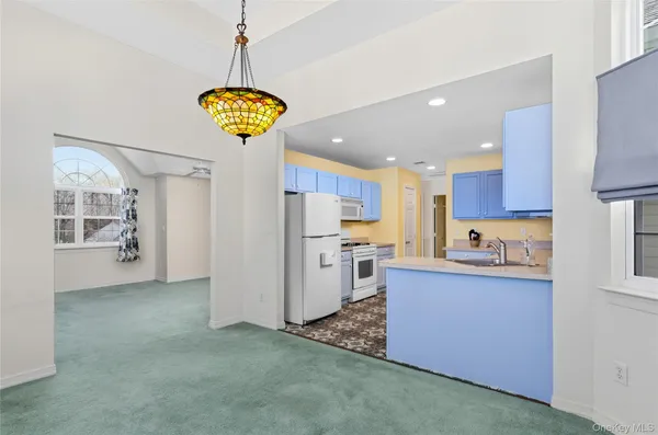 a kitchen with refrigerator and window