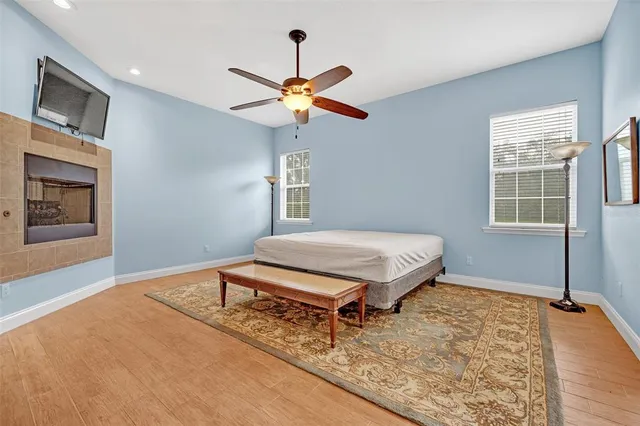 an empty room with a window and a fan