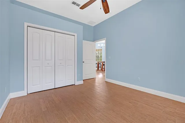 a view of a big yard with plants and large trees