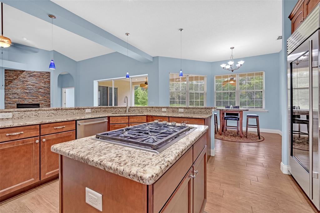 9824 Brantley Road Lithia, FL 33547 - Photo 10 of 38 a kitchen with stainless steel appliances granite countertop a stove and a sink