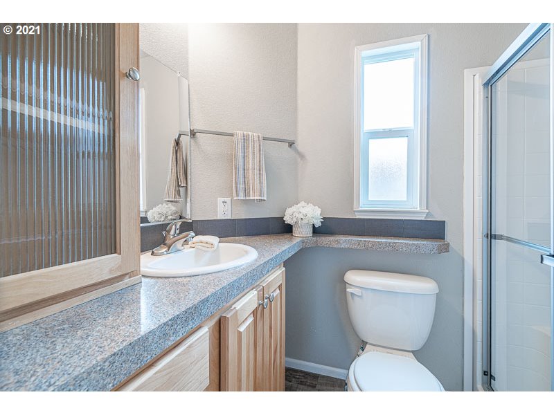 8372 Enchanted Way Southeast, Unit 192 Turner, OR 97392 - Photo 15 of 27 a bathroom with a toilet sink and mirror