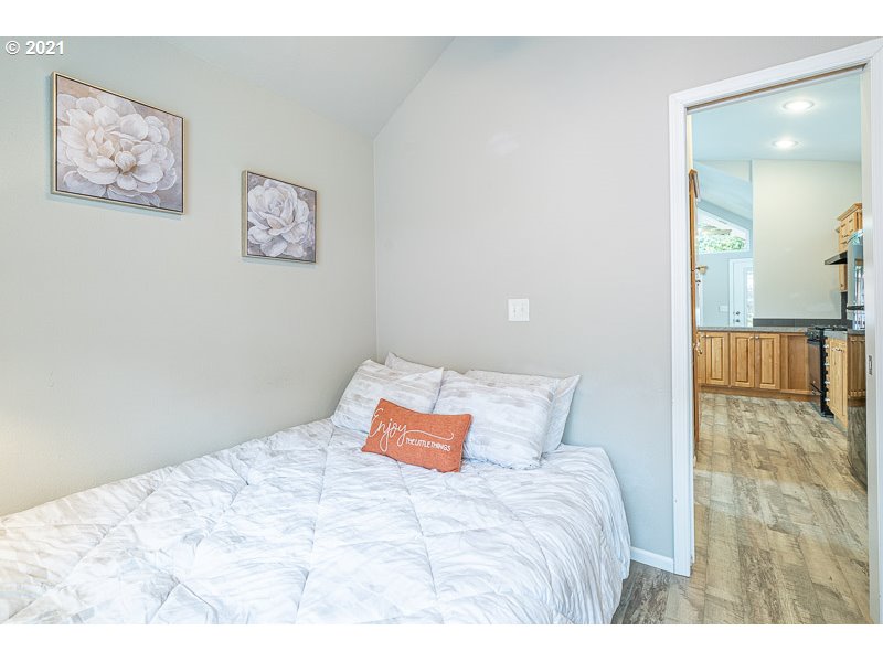 8372 Enchanted Way Southeast, Unit 192 Turner, OR 97392 - Photo 17 of 27 a bedroom with a bed and painting on the wall