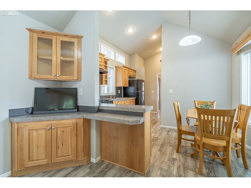 8372 Enchanted Way Southeast, Unit 192 Turner, OR 97392 - Photo 6 of 27 a kitchen with cabinets and chairs