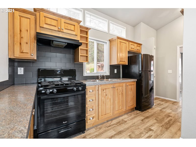 8372 Enchanted Way Southeast, Unit 192 Turner, OR 97392 - Photo 9 of 27 a kitchen with stainless steel appliances granite countertop a stove a refrigerator and a granite counter tops