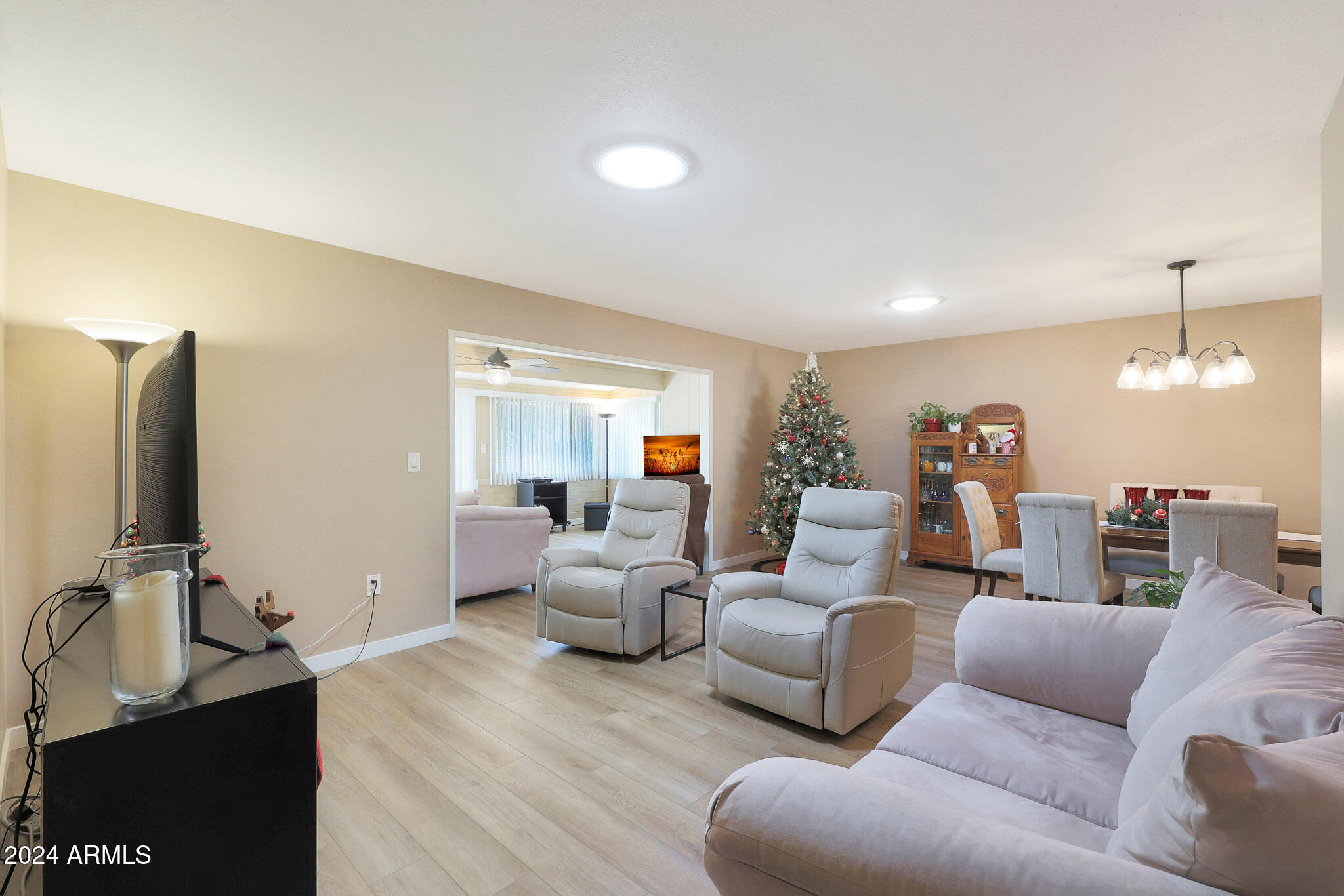 10137 West Mountain View Road Sun City, AZ 85351 - Photo 11 of 34 a living room with furniture and a flat screen tv